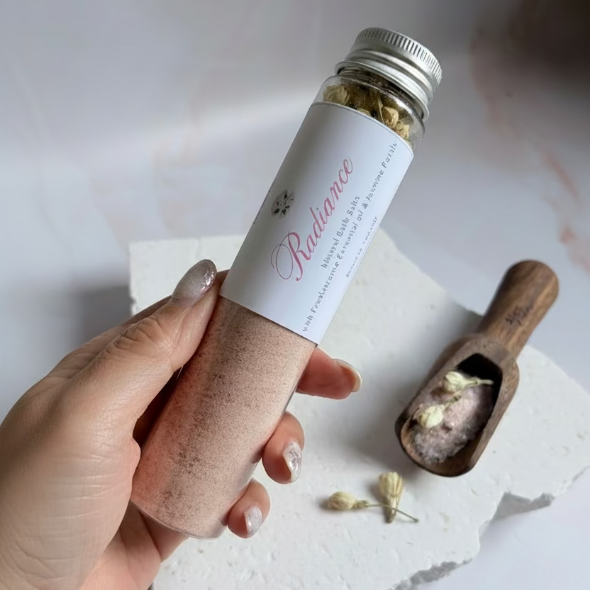 Hand holding a bottle labeled &