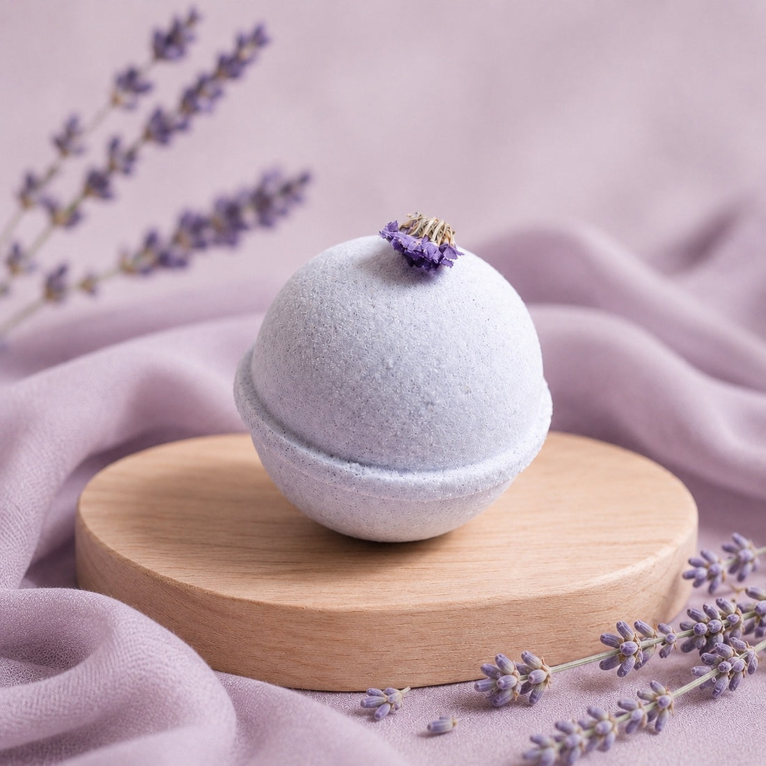 Bath bomb with lavender flowers on a wooden stand against a soft pink background