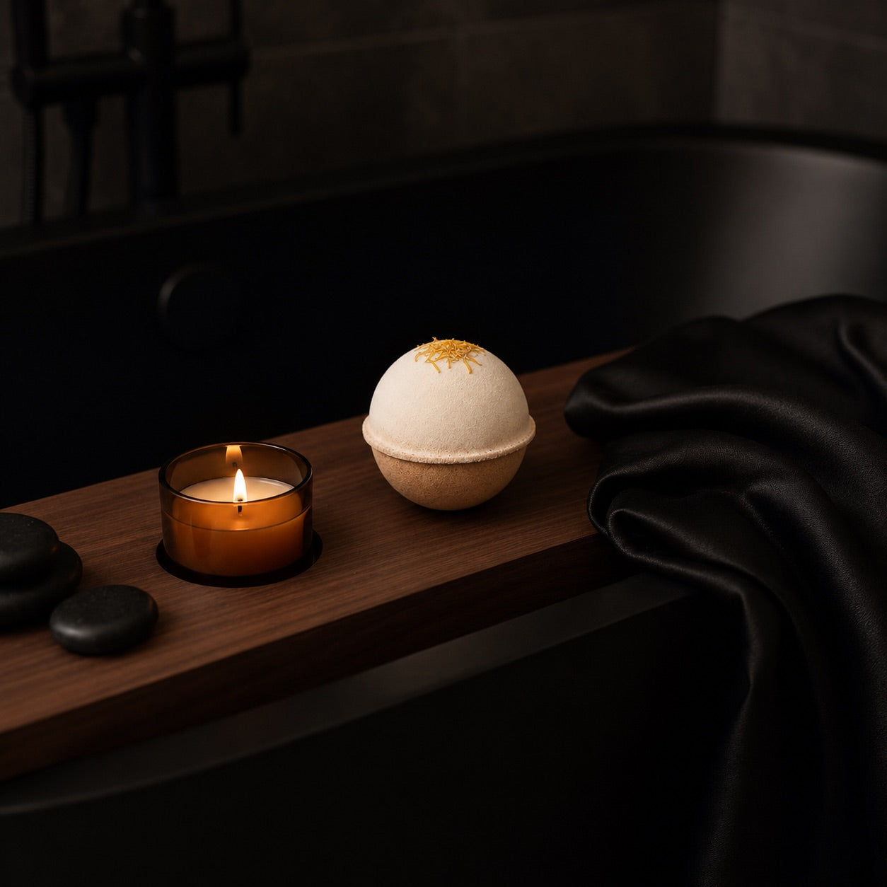 Bath bomb and candle on a wooden tray with a dark background