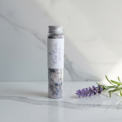 Tub of bath salts with a label on a neutral background