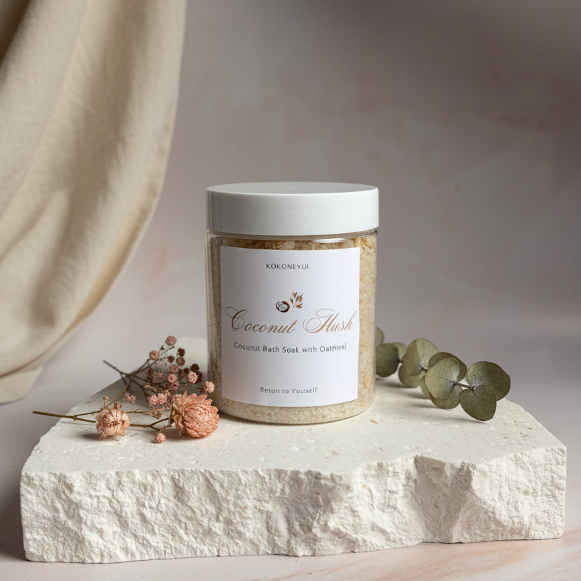 Jar of coconut Hush on a textured surface with a neutral background