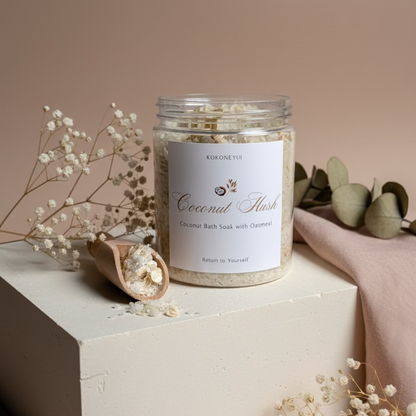 Jar of coconut bath Soak with a scoop on a textured surface