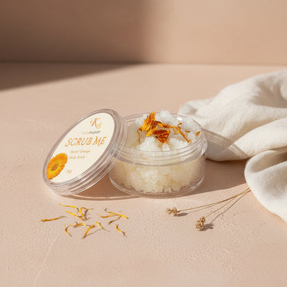 Clear container with body scrub and lid featuring branding on a light gray background