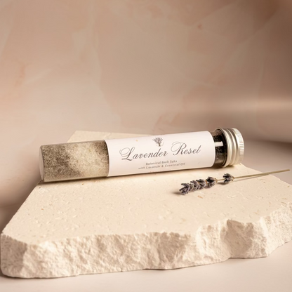 Lavender Reset product on a textured white surface with a light pink marble background