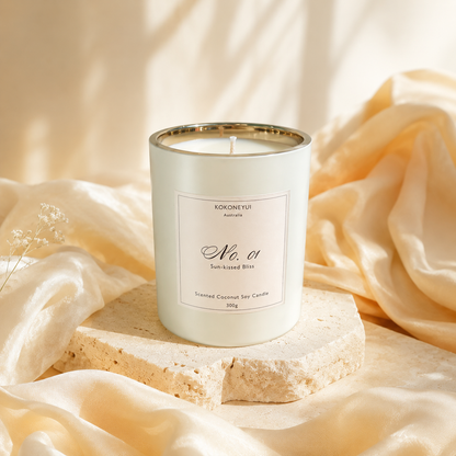 White candle in a decorative container with a label on a soft fabric background