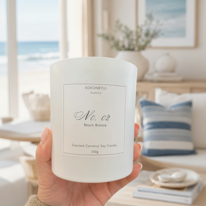 Hand holding a white candle labeled &