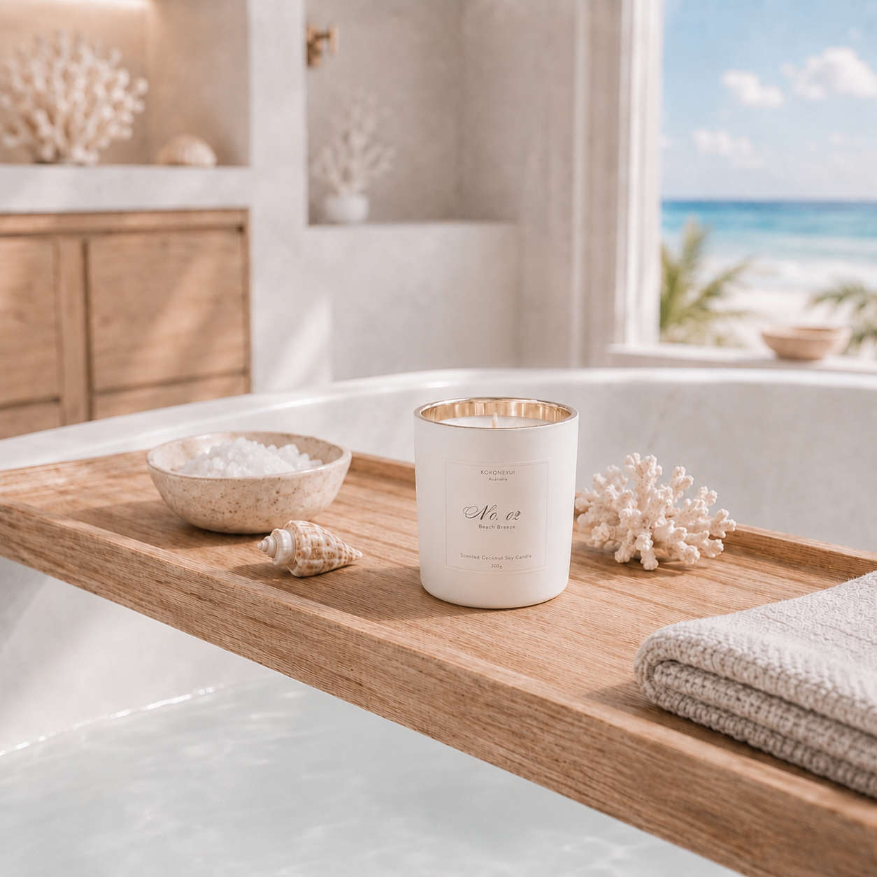 Candle with a shell and towel on a wooden tray by a window with a beach view