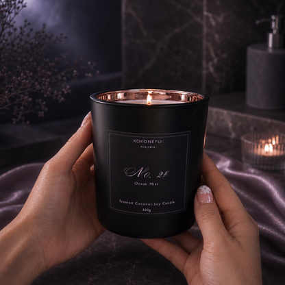 Person holding a black candle labeled &
