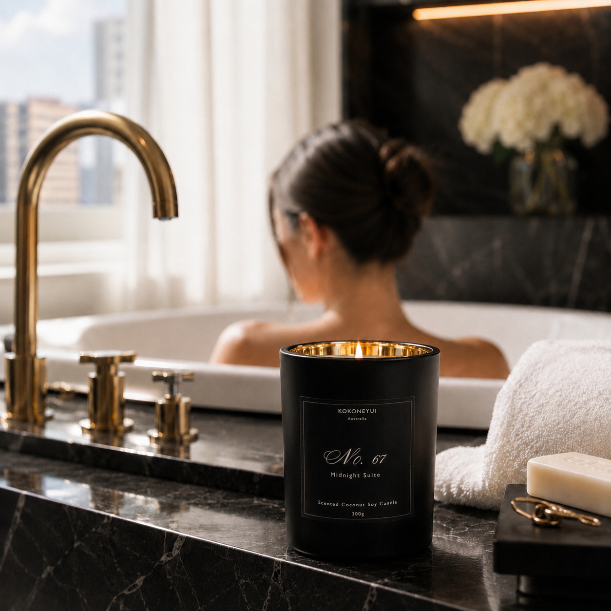 Woman in a bathtub with a candle on the counter, surrounded by bathroom decor.