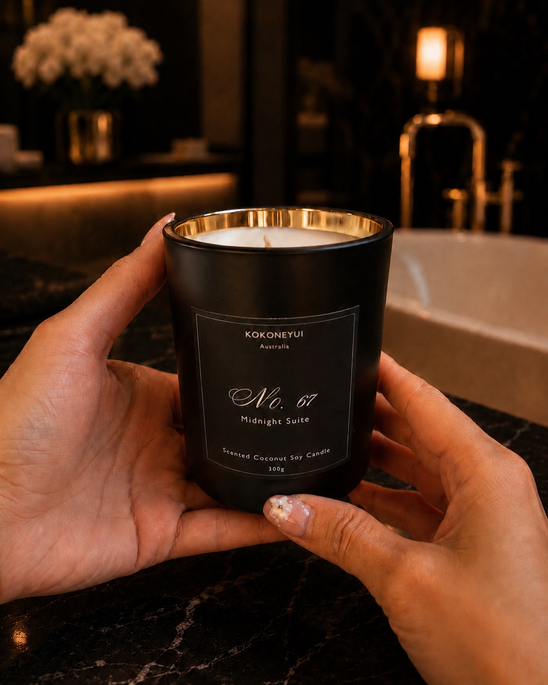 Person holding a black candle labeled &