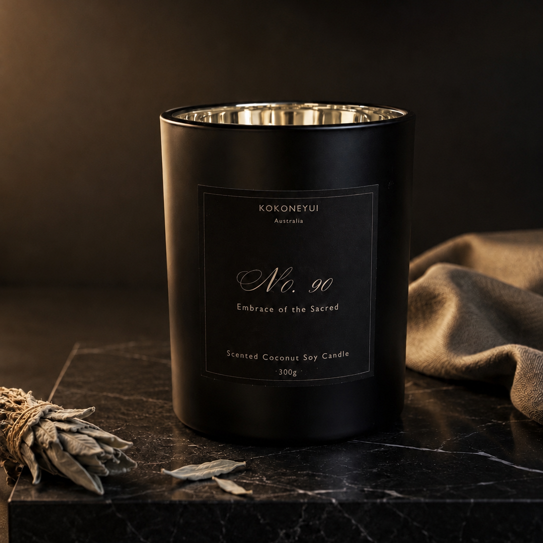 Black candle with a label on a dark surface