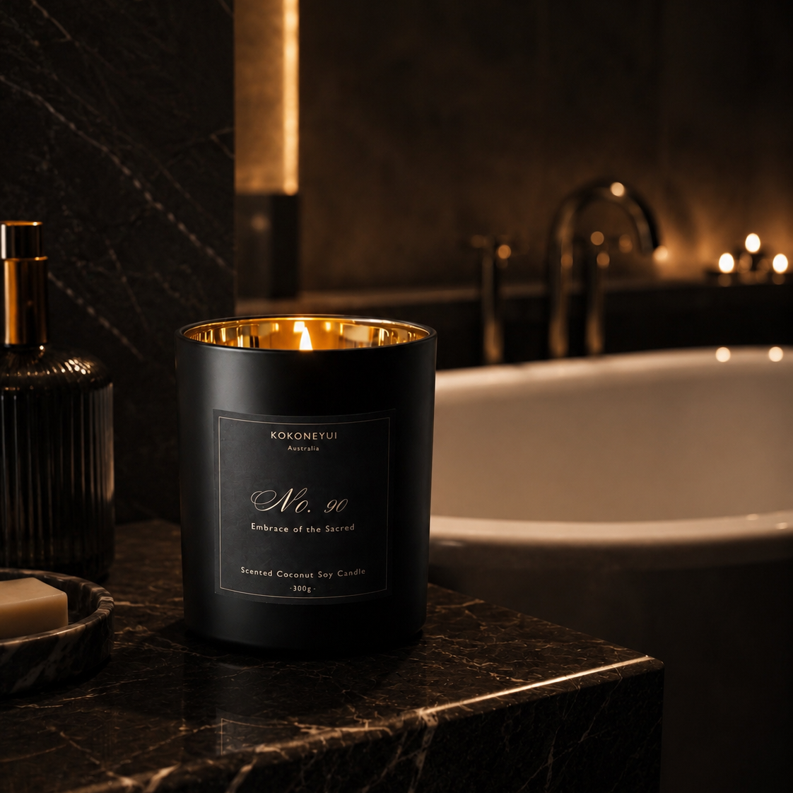 Candle with a gold interior on a marble surface next to a bathtub in a dimly lit room.