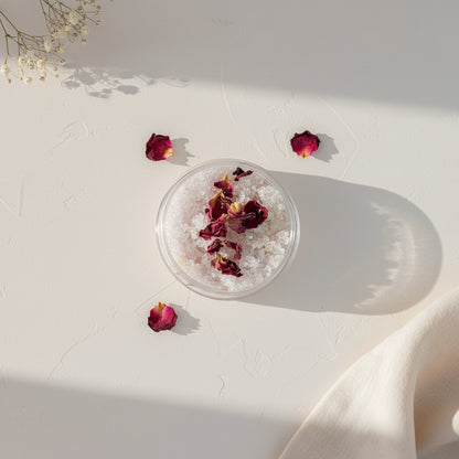 Small Scrub container with dried Rose flowers on a light gray background