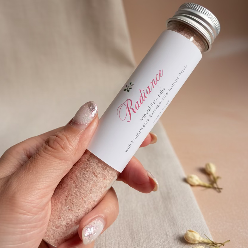 Hand holding a skincare product labeled &