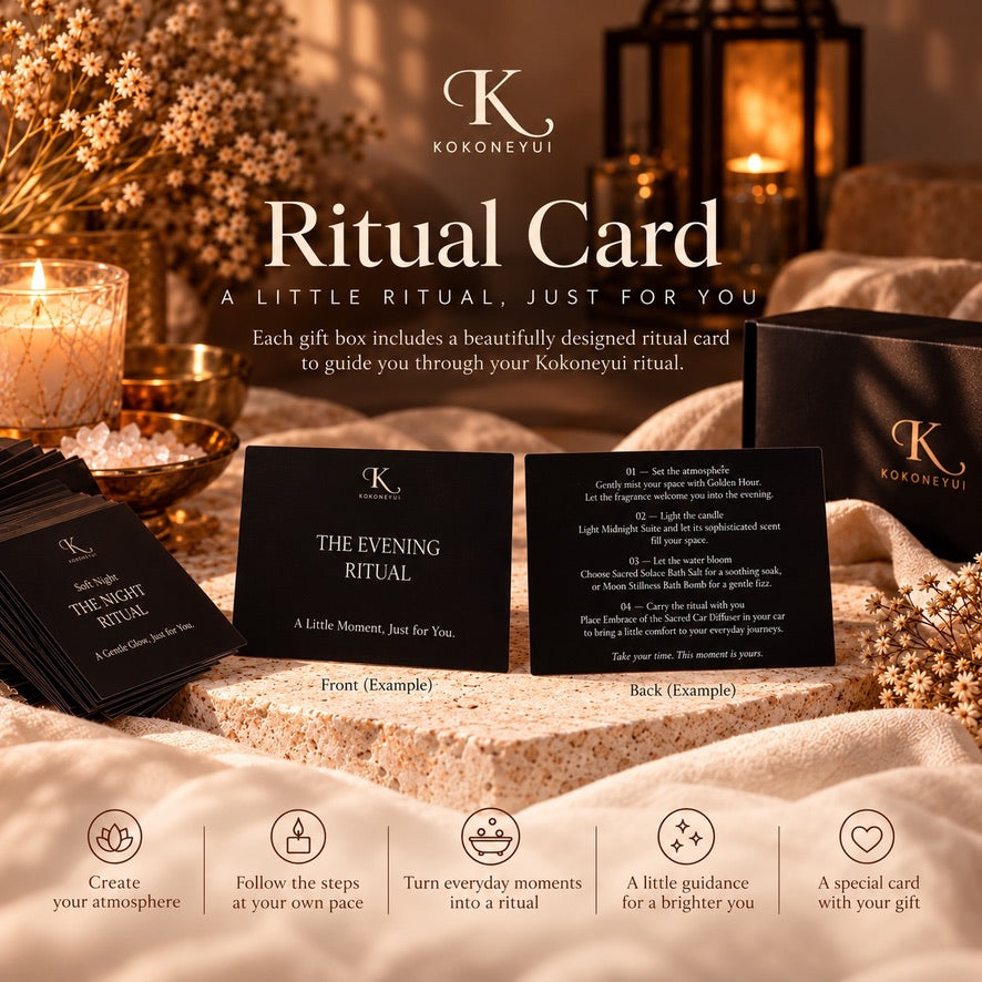 Kokonevui Ritual Cards shown in a styled home setting with candles, dried flowers, and gift boxes. The image features sample front and back views of the black ritual cards, along with a stack of cards and branded black gift boxes on a soft beige blanket.