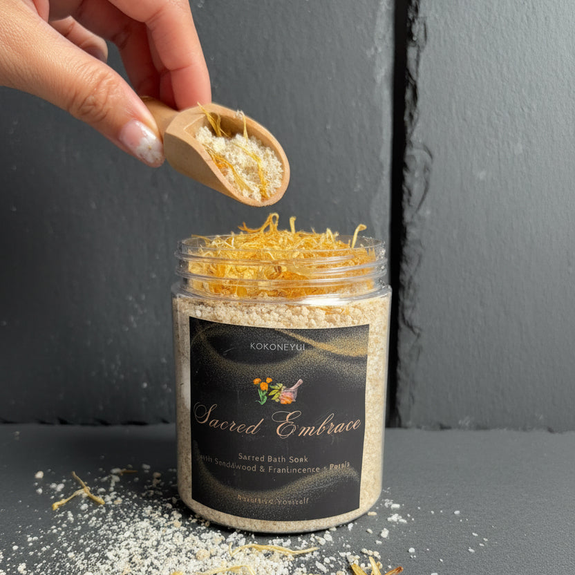 Hand pouring bath soak from a jar labeled &