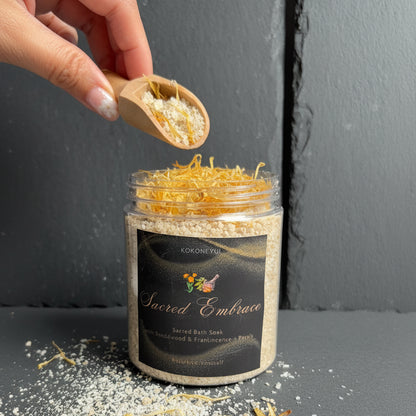 Hand pouring bath soak from a jar labeled &