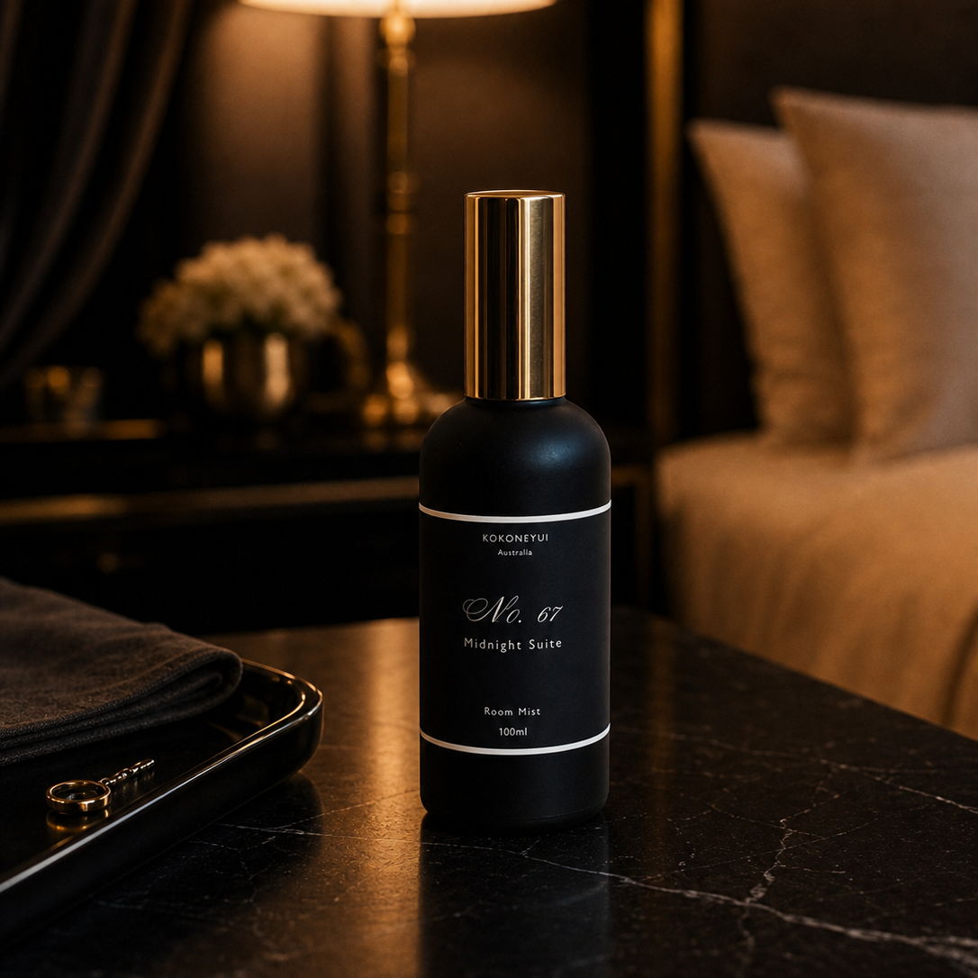 Room Mist  Bottle on a dark surface with a blurred background of a room.